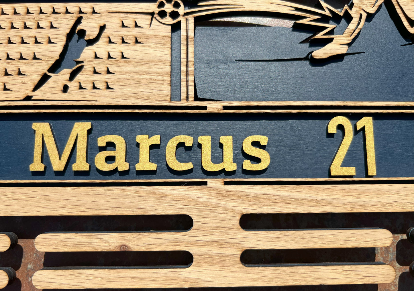 Close up personalization on soccer medal display.