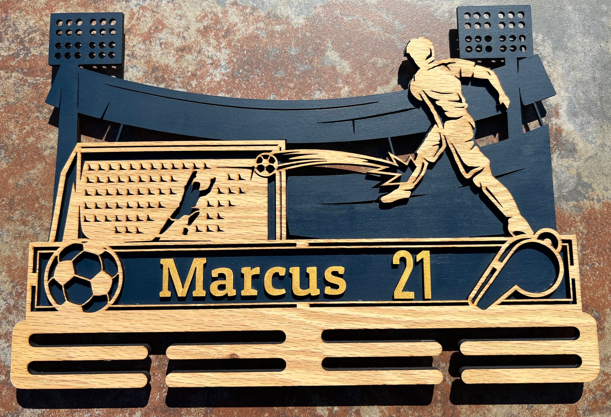 Male soccer player medal wall mount display. Personlized with name and number. Color displayed is Navy & Gold with oak wood front.